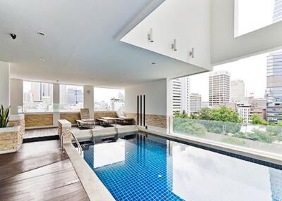 Rooftop swimming pool area with city view