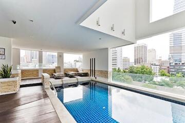 Rooftop swimming pool area with city view
