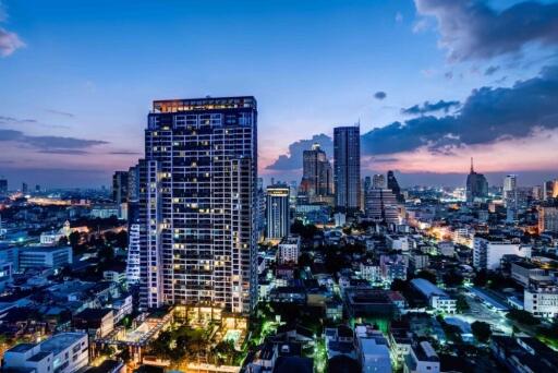 Skyline view of a city with tall buildings at dusk