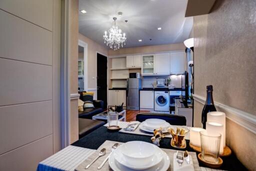 Modern kitchen and dining area with chandelier