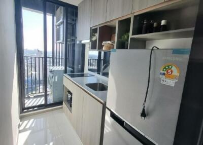 Modern kitchen with large refrigerator and balcony view