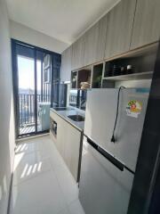 Modern kitchen with large refrigerator and balcony view