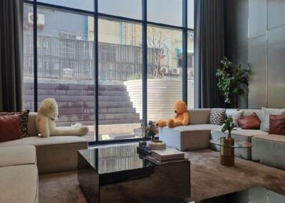 Modern living room with large windows and plush seating