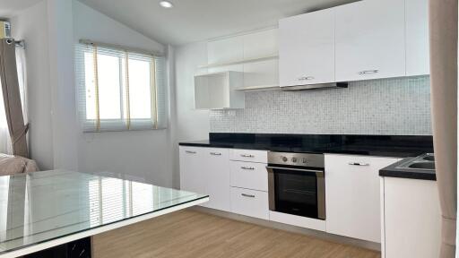 Modern kitchen with white cabinets and black countertops