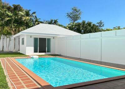 Outdoor area with pool and guest house