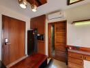 Well-lit bedroom with wooden decor and air conditioning