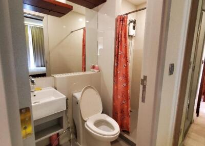 Modern bathroom with sink, toilet, and shower