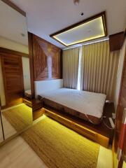 Modern bedroom with illuminated ceiling and floor, large wardrobe, bed, and curtains