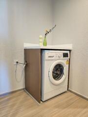 Compact laundry area with front-load washing machine