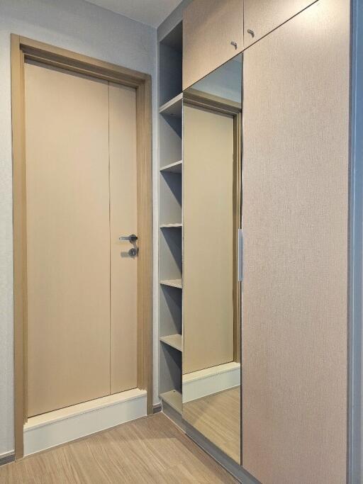 Hallway with wooden door and built-in wardrobe