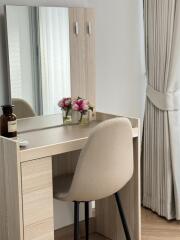 Bedroom vanity with chair and flowers