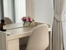 Bedroom vanity with chair and flowers