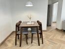 Modern dining area with wooden table and four chairs