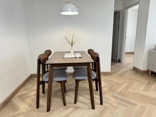 Modern dining area with wooden table and four chairs
