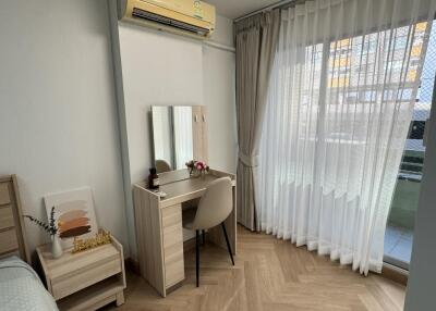 Bedroom with desk and large window