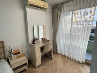 Bedroom with desk and large window