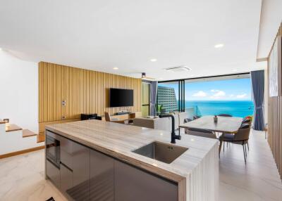 Modern open-plan kitchen and living room with ocean view