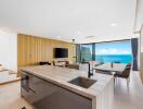 Modern open-plan kitchen and living room with ocean view