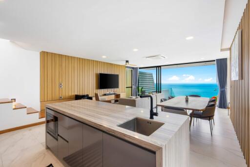 Modern open-plan kitchen and living room with ocean view