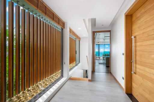 Modern hallway with large wooden slats and ocean view