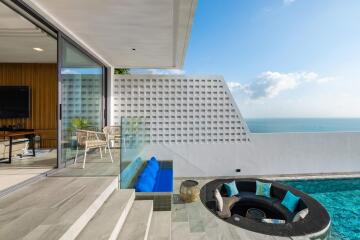 Modern outdoor seating area with pool and ocean view