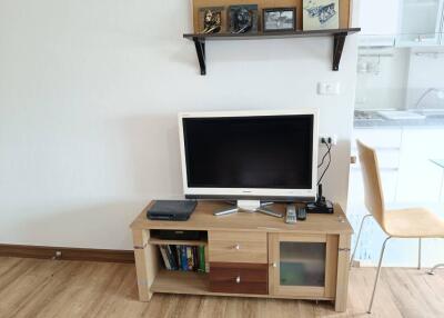 living room with TV cabinet and wall shelf