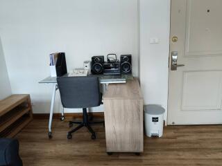 Home office setup with desk, chair, and sound system