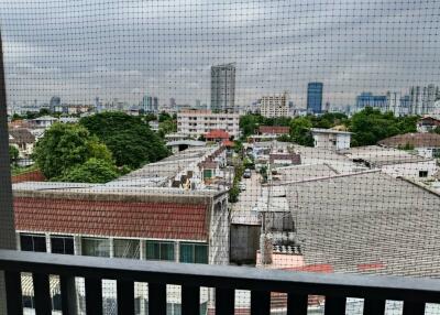 View from the balcony showing cityscape and nearby residential area