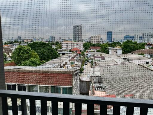 View from the balcony showing cityscape and nearby residential area