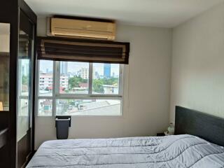 Bedroom with large window and city view