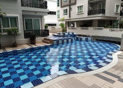 Outdoor swimming pool area in a residential complex