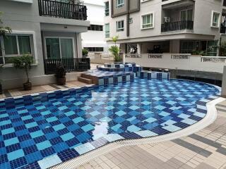 Outdoor swimming pool area in a residential complex