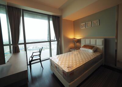 Bedroom with large window and city view