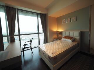 Bedroom with large window and city view