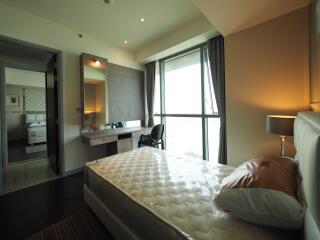 Modern bedroom with attached bathroom and large window