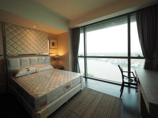 Modern bedroom with large window and scenic view