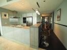 Modern kitchen with breakfast bar and stainless steel appliances