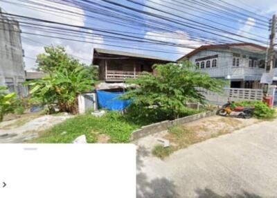 Street view of residential neighborhood with houses and greenery