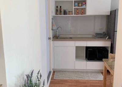 Modern kitchen with white cabinetry and wooden flooring