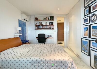 Spacious and well-lit bedroom with workspace and decor