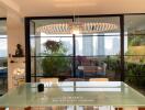 Modern dining room with glass table and city view