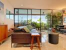 Spacious living room with large windows and indoor plants