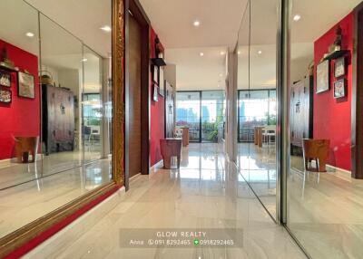 Bright hallway with large mirrors and tiled floor