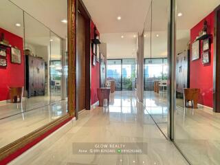 Bright hallway with large mirrors and tiled floor