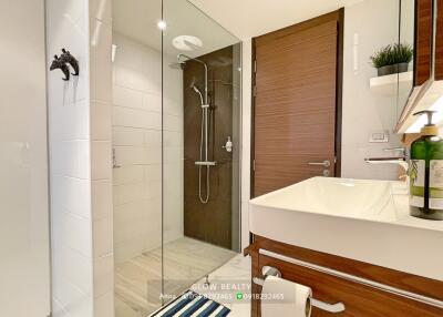 Modern bathroom with glass shower and wooden accents