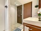 Modern bathroom with glass shower and wooden accents