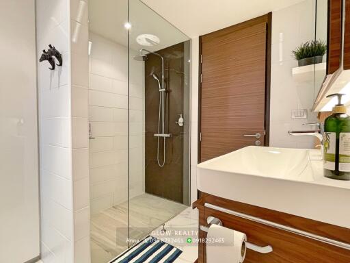 Modern bathroom with glass shower and wooden accents