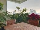 Outdoor dining area with plants and city view