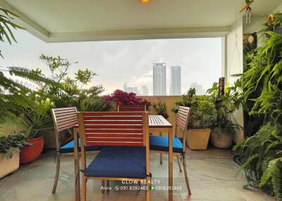 A cozy balcony with a dining set and plants