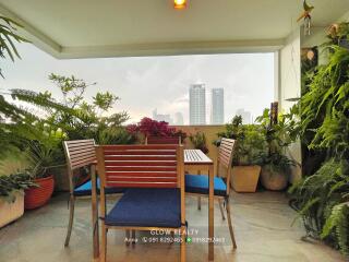 A cozy balcony with a dining set and plants